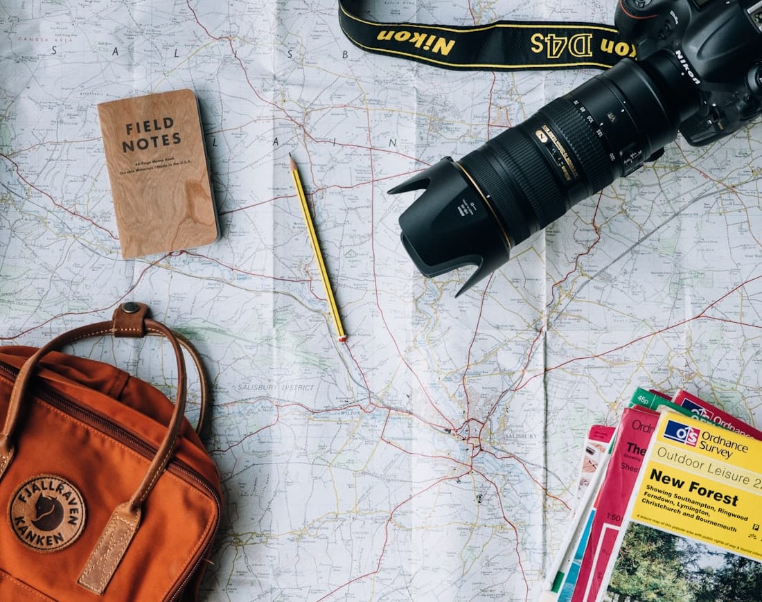 Travel journal, map and camera laid out for planning